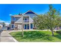 Inviting townhome with blue siding, stone accents, a balcony, and a well-manicured lawn at 23413 E Dorado Pl # A, Aurora, CO 80016