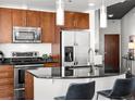 Modern kitchen features stainless steel appliances, sleek black countertops, and stylish pendant lighting at 891 14Th St # 3204, Denver, CO 80202