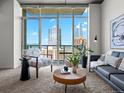 Inviting living room filled with natural light from large windows offering panoramic city views at 891 14Th St # 3204, Denver, CO 80202