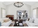 Open-concept living space with view to the kitchen and piano at 8739 E 23Rd Ave, Denver, CO 80238