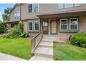 Inviting townhome entrance with landscaped garden, flowers, and a shared front porch at 17151 E Stanford Ave # B, Aurora, CO 80015