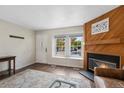 Living room with hardwood floors, bright window and a cozy fireplace with wooden mantel at 17151 E Stanford Ave # B, Aurora, CO 80015