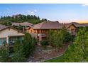 Rear exterior view of house showing a deck overlooking treed common area and neighborhood at 4336 Chateau Ridge Rd, Castle Rock, CO 80108
