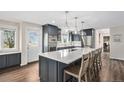Spacious kitchen boasts a large island with seating, pendant lights, stainless appliances and a back door at 28800 E 168Th Ave, Brighton, CO 80603