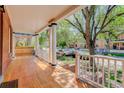 Expansive front porch with stately pillars, offering ample space for outdoor relaxation and neighborhood views at 729 E 10Th Ave, Denver, CO 80203