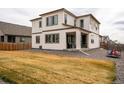 Spacious backyard with a covered patio, modern grill, and a well-maintained lawn area perfect for outdoor activities at 13329 Newport Cir, Thornton, CO 80602
