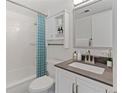 Well-maintained bathroom with shower-tub, vanity, and white tile at 9100 E Girard Ave # 7, Denver, CO 80231