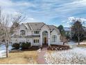 Handsome two-story home featuring an arched entryway, and a brick walkway at 8 Mountain Willow Dr, Littleton, CO 80127