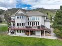 Spacious home featuring a large deck with seating and a walkout basement at 8 Mountain Willow Dr, Littleton, CO 80127
