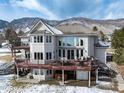 Spacious two-story home with a large deck that offers outdoor seating and a mountain view at 8 Mountain Willow Dr, Littleton, CO 80127