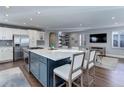 Modern, open-concept kitchen featuring a large island with seating, stainless steel appliances, and sleek cabinetry at 515 S Grant St, Denver, CO 80209
