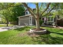 Beautiful home showcasing a mature tree in a landscaped front yard and cozy porch at 2667 E 132Nd Ave, Thornton, CO 80241