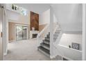 A cozy living room with a fireplace and staircase at 4006 S Atchison Way, Aurora, CO 80014