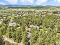 An aerial view of the property, showcasing its location in a beautiful and private wooded area at 1240 Lone Scout Lookout, Monument, CO 80132