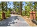 A long driveway leads up to the house with beautiful brick pillars lining the entrance at 1240 Lone Scout Lookout, Monument, CO 80132