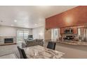 Open living space featuring a fireplace, sliding glass doors, and a kitchen with a breakfast bar at 519 Wright St # 304, Lakewood, CO 80228