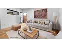Cozy living room featuring a neutral-toned sofa, modern coffee table, and stylish decor accents at 1737 Lowell Blvd, Denver, CO 80204