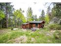 Cozy cabin with rustic details and outdoor seating area, perfect for enjoying the natural surroundings at 12346 Bear Haven Rd, Conifer, CO 80433