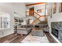 Inviting living room with a modern fireplace, wooden accents, and staircase at 943 S Fairplay St, Aurora, CO 80012