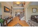 Grand foyer featuring hardwood floors, staircase, and a decorative chandelier at 8655 E 130Th Ave, Thornton, CO 80602