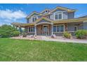 Charming home showcasing a covered front porch with stone accents and a well-kept lawn at 8655 E 130Th Ave, Thornton, CO 80602