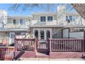 A cozy back porch with a maroon wood fence and doors that lead into the house at 5252 W 68Th Ave, Arvada, CO 80003
