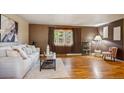 Cozy living room features hardwood floors, a large window, and comfortable seating arrangement at 3871 W Saratoga Ave, Littleton, CO 80123