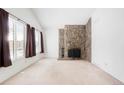Bright living room boasts a unique stone fireplace, perfect for cozy evenings at 16035 E Ithaca Pl # D, Aurora, CO 80013