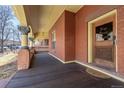 Inviting porch featuring brick columns, a wooden ceiling, and an elegant entrance door at 1435 Vine St # 2, Denver, CO 80206