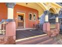 Welcoming porch with ornate columns, dark wood floor, and a vintage door for added appeal at 1435 Vine St # 2, Denver, CO 80206