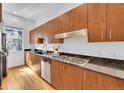 A chef-ready kitchen with stainless appliances, gas range, sleek counters, and rich wood cabinetry at 2680 Blake St # 13, Denver, CO 80205