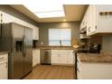 Bright kitchen featuring stainless steel appliances, white cabinetry, and wood flooring at 5555 E Briarwood Ave # 706, Centennial, CO 80122