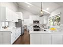 Bright kitchen featuring white cabinets, stainless steel appliances, and hardwood floors at 10795 E Powers Dr, Englewood, CO 80111