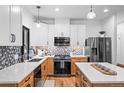 Modern kitchen with light cabinets, quartz counters, and stainless steel appliances at 950 Tenderfoot Dr, Larkspur, CO 80118