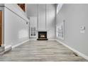 Open-concept living room features a fireplace, light wood flooring, and lots of windows at 19731 E 40Th Ave, Denver, CO 80249