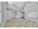 Open-concept living room features stairs, light wood flooring, and natural light at 19731 E 40Th Ave, Denver, CO 80249