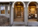 Inviting front door with stone wall accents and cozy seating area at 2618 S Kilmer Ct, Denver, CO 80228