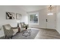 Bright living room featuring wood floors, a large window, and stylish decorative accents at 21486 E Crestline Ln, Centennial, CO 80015