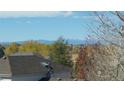 Scenic view of mountains in the distance, seen from a residential home, fall colors and trees are visible at 21486 E Crestline Ln, Centennial, CO 80015