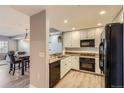Modern kitchen with white cabinets, granite countertops, and stainless steel appliances at 975 N Lincoln St # 4I, Denver, CO 80203