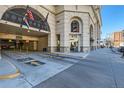A covered parking garage entrance with visible arrows on a concrete surface under the building at 975 N Lincoln St # 4I, Denver, CO 80203