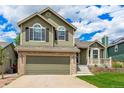 Charming two-story home featuring an attached two-car garage and well-maintained lawn at 863 Homestead Dr, Highlands Ranch, CO 80126