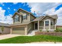 Charming two-story home featuring an attached two-car garage and well-maintained lawn at 863 Homestead Dr, Highlands Ranch, CO 80126