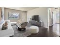 Stylishly furnished living room featuring hardwood floors, a large window, and neutral decor at 2865 S Fairfax St, Denver, CO 80222