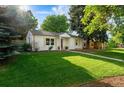 Inviting single story home features a lush green lawn and well-maintained landscaping with mature shade trees at 3047 N Milwaukee St, Denver, CO 80205