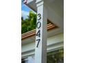 Close-up of the house number '3047' displayed in modern, black numerals attached to a white pillar at 3047 N Milwaukee St, Denver, CO 80205