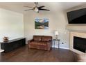 Cozy living room features a fireplace, ceiling fan, and stylish decor at 9557 W San Juan Cir # 207, Littleton, CO 80128