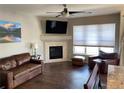 Comfortable living room features a fireplace, ceiling fan, and lots of natural light at 9557 W San Juan Cir # 207, Littleton, CO 80128