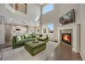 Spacious living room featuring a fireplace, high ceilings, large windows, and comfortable seating at 17124 Mariposa St, Broomfield, CO 80023
