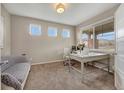 Cozy home office with a large window, neutral colors, and comfortable seating at 17124 Mariposa St, Broomfield, CO 80023